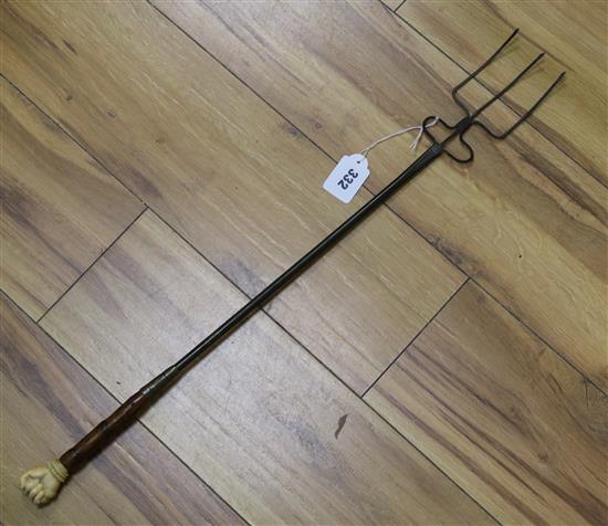 An ivory-handled cane handle in the shape of a fist, later converted